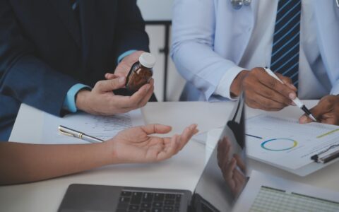 Equipe de médicos e empresária tendo uma reunião no consultório médico